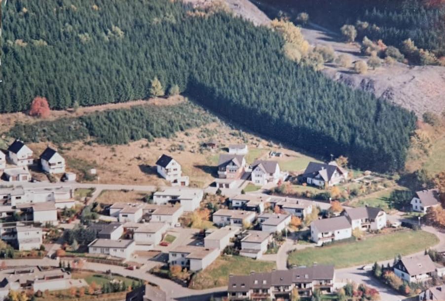 Luftaufnahme des Schieferwegs mit Wohnbebauung und der Schiefergrube im Hintergrund